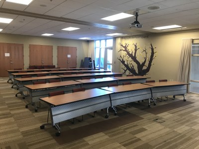 Community Room with tables in classroom setup, north facing