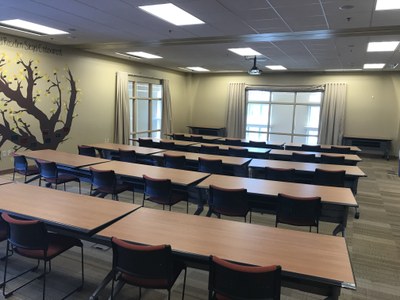 Community Room with tables in classroom setup, south facing