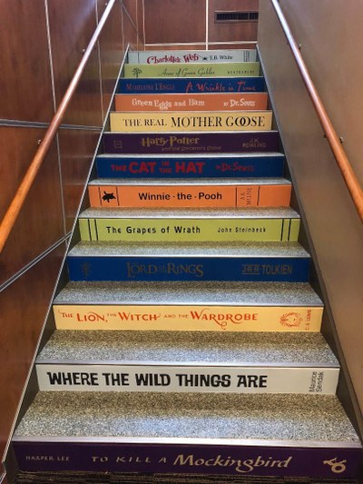 Lower Stairs Photo of the 1st flight of stairs with book spine titles on risers
